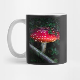 Bright red magical mushroom with white spots deep in the forest Mug